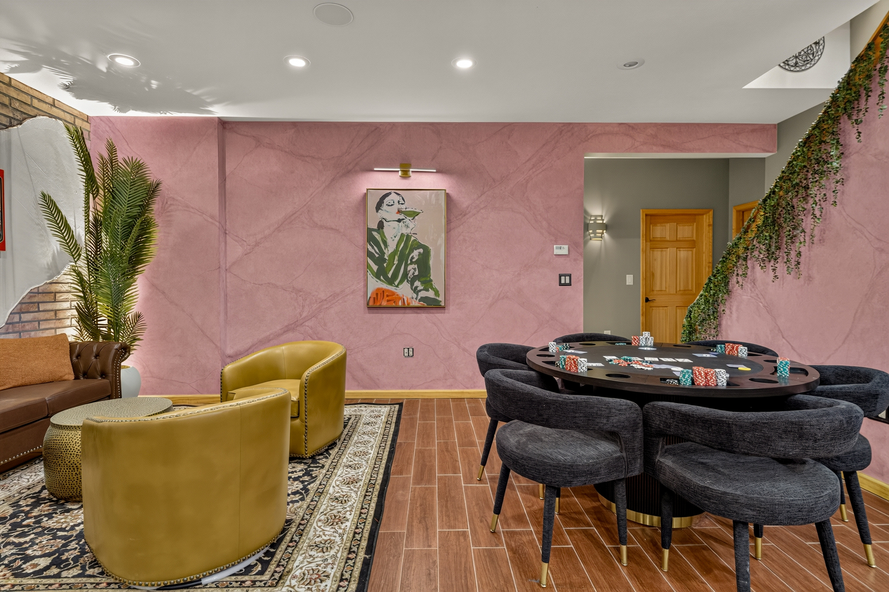 Poker table with upholstered chairs and nearby lounge seating