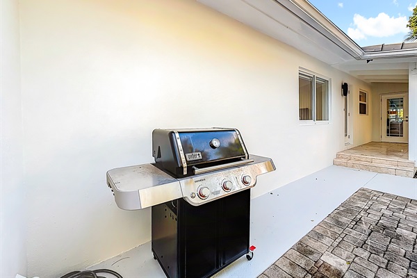 New Weber gas grill with 2 propane tanks- Ready to grill just outside the kitchen. 
