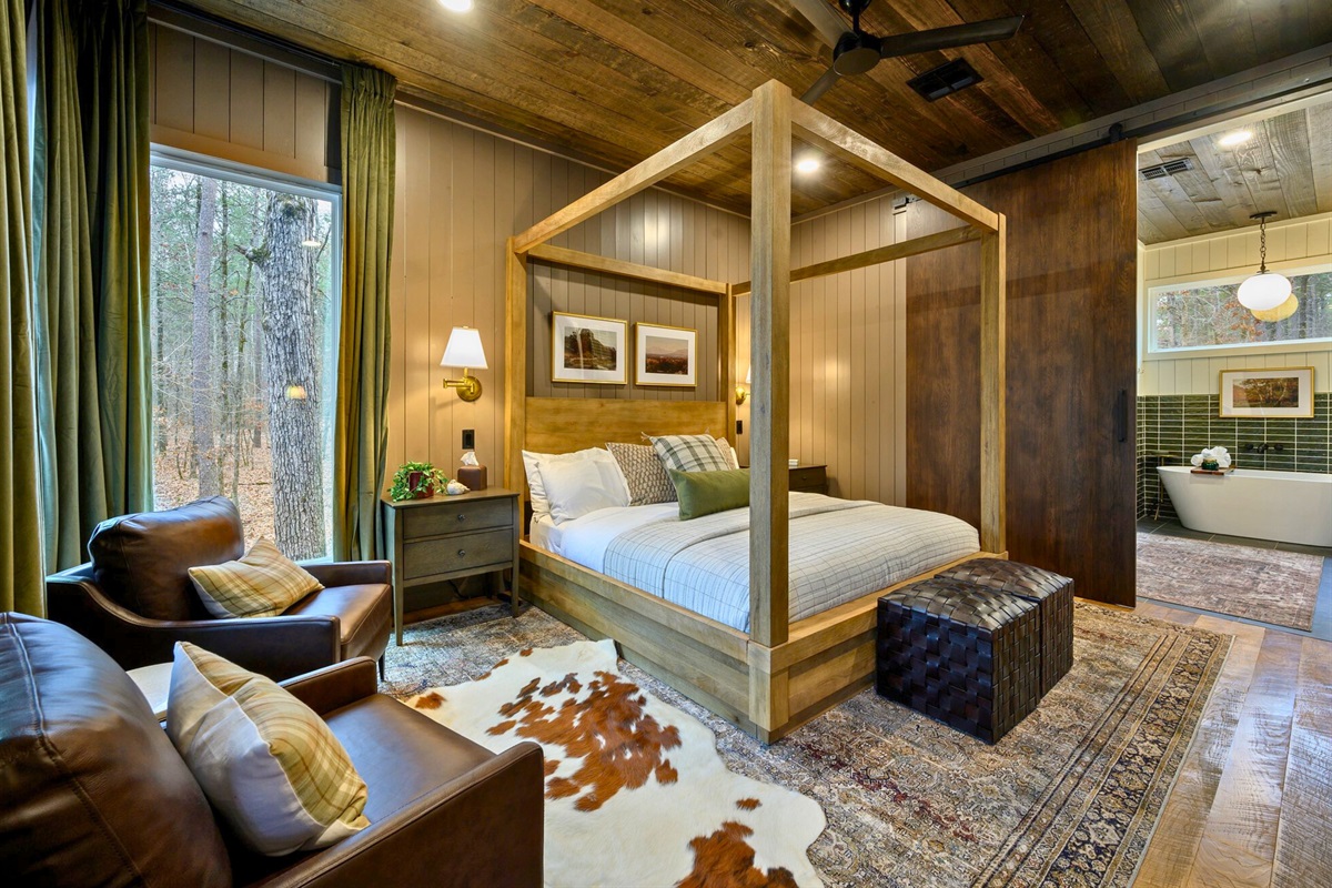 A closer look shows comfortable seating and a beautiful canopy bed that adds a touch of rustic charm.
