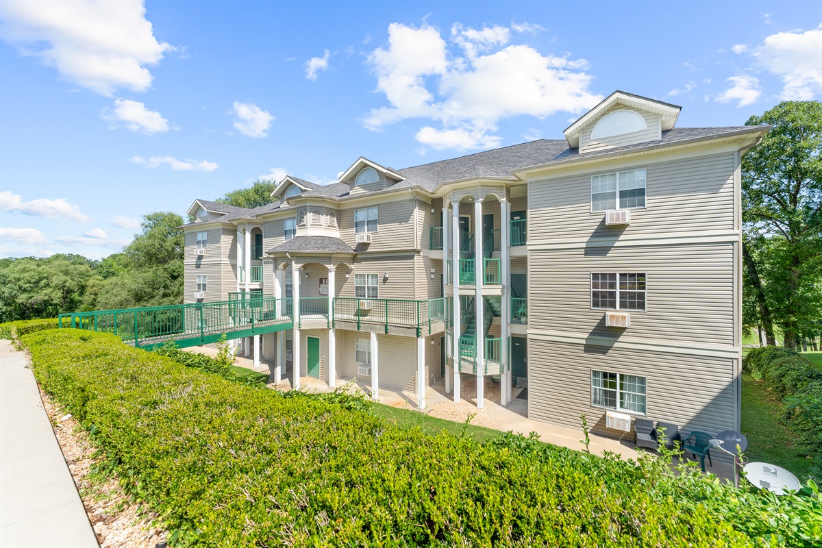 Side exterior view shows the building layout and the easy-access walkway to the unit.
