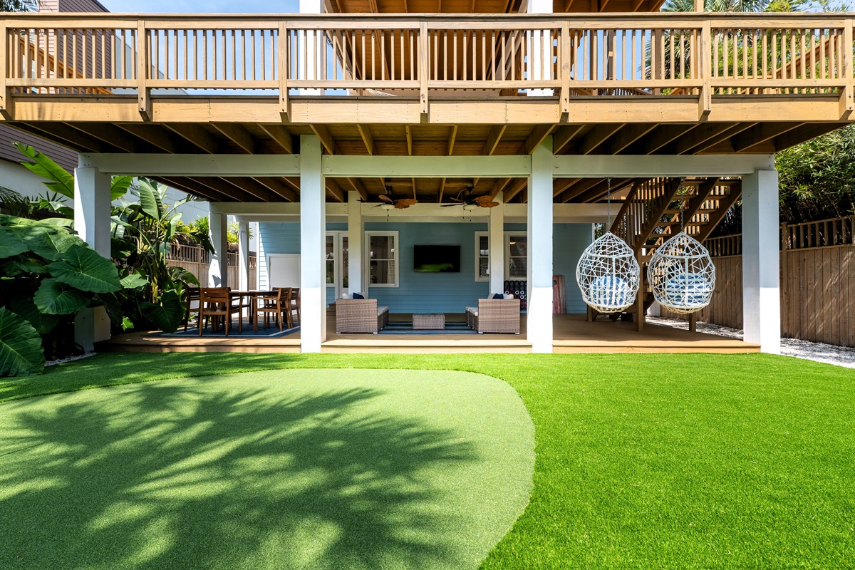 Your private backyard retreat - lush lawn, lounge seating, games, and green space to unwind.