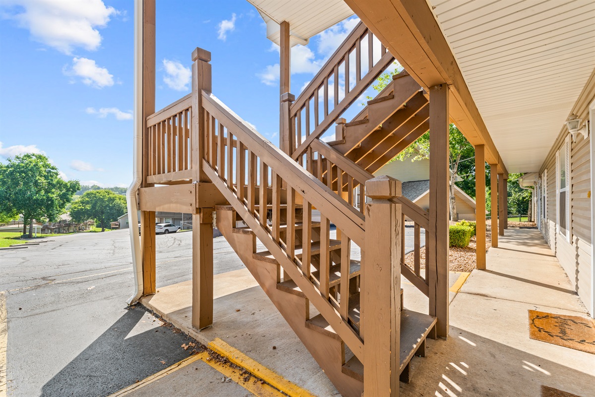 Exterior stairs lead to the condo’s upper-level entry.