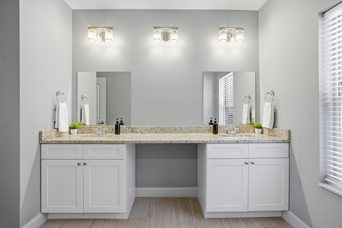 Start your morning here—plenty of counter space, double sinks, and room for everyone to get ready without bumping elbows. Spread out your things, take your time, and ease into the day.