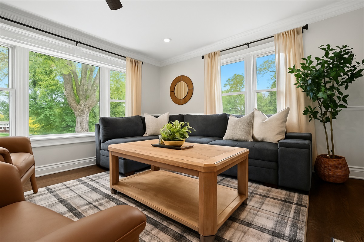 Bright, inviting living room with large windows, cozy sectional, and stylish decor—perfect for relaxing after a day on the lake.