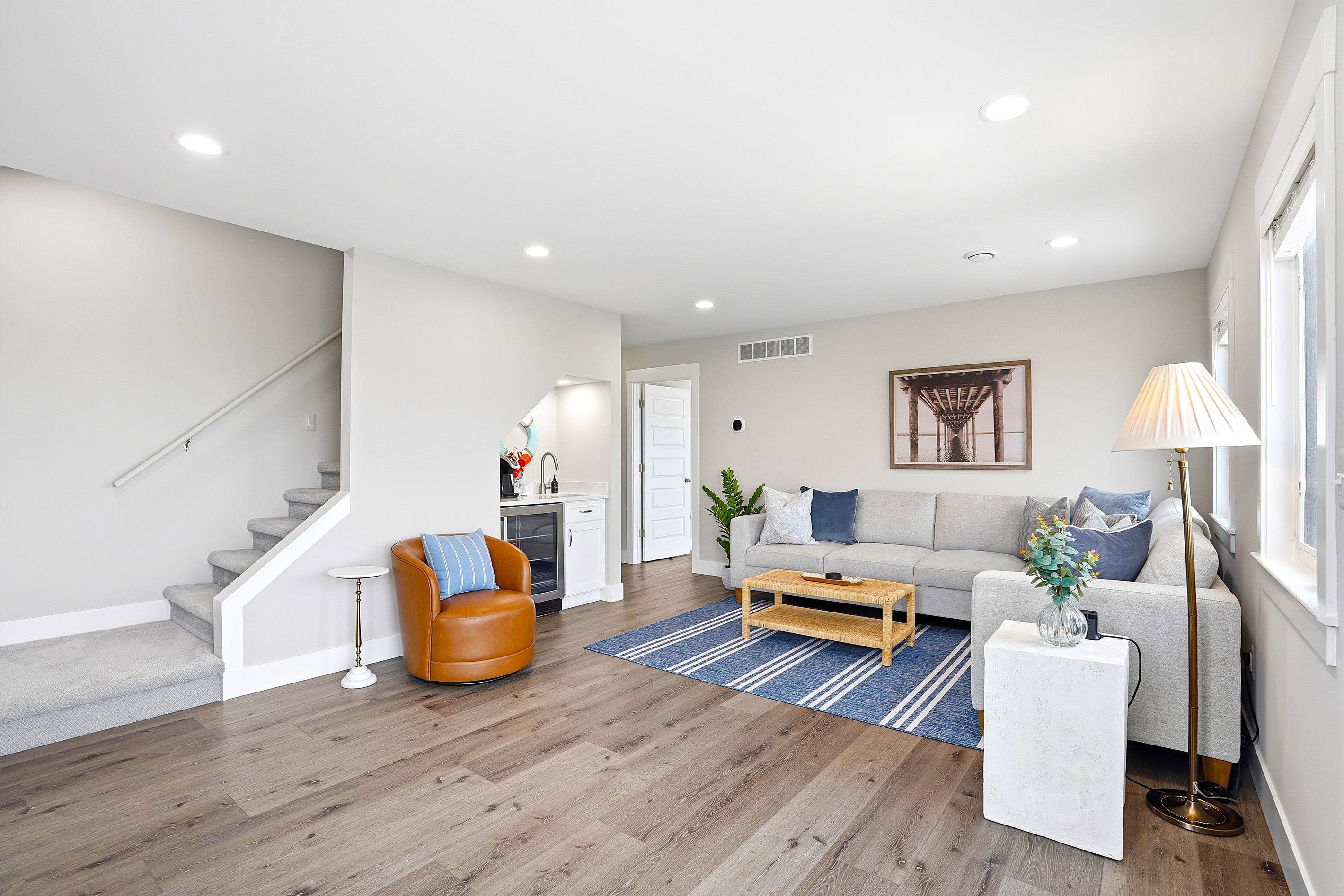 Just beyond the living room, the staircase leads to the third-floor bedroom, creating a private upper-level retreat while keeping everyone connected to the home's shared gathering space.