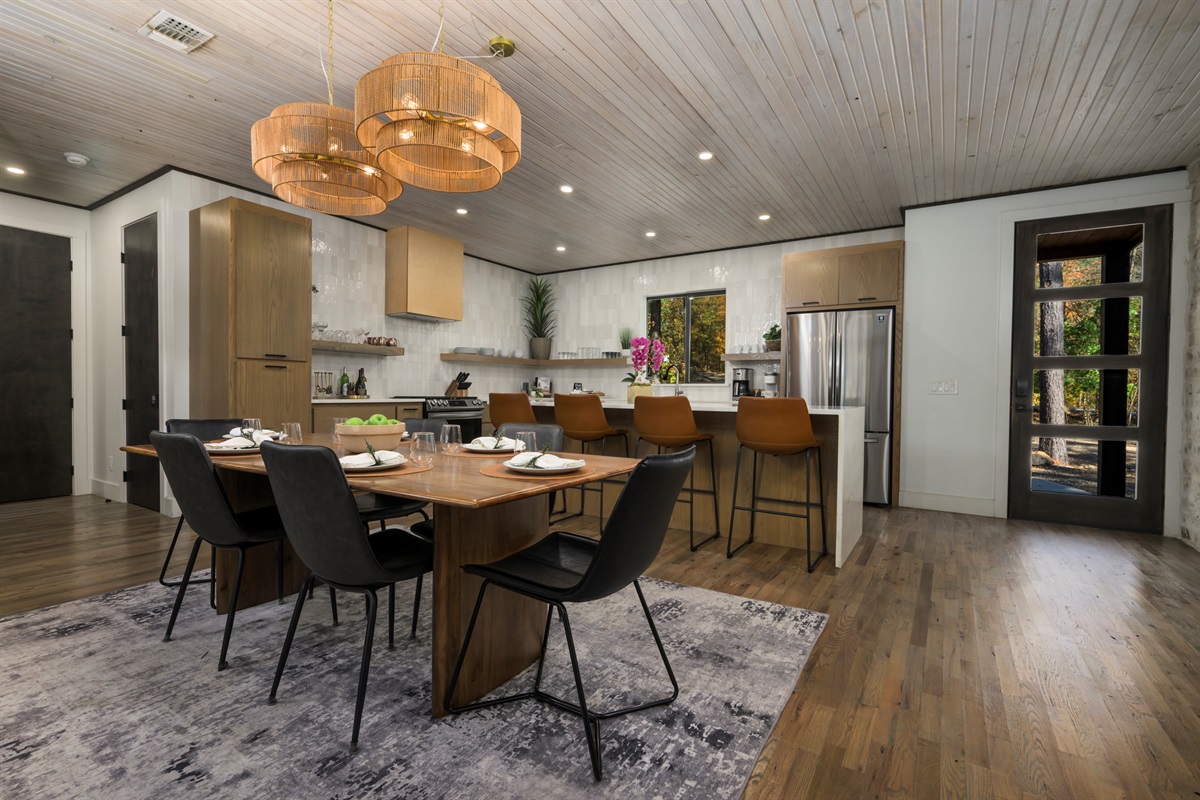 Open-concept kitchen and dining area in our luxury Broken Bow cabin, perfect for family meals and entertaining