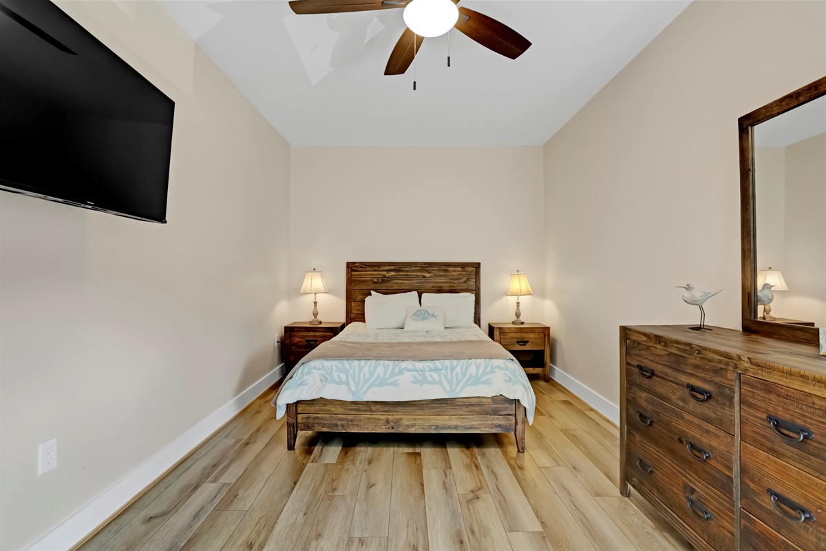 Rest easy in the spacious primary bedroom with plush bedding.