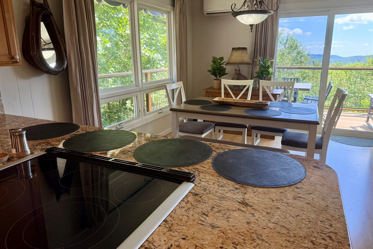 Dining with amazing views! Our dining table seats 6 (with 4 chairs + 1 bench that seats 2 more) & 4 barstools that are beside this table, under the kitchen counter bar to seat 10 total.