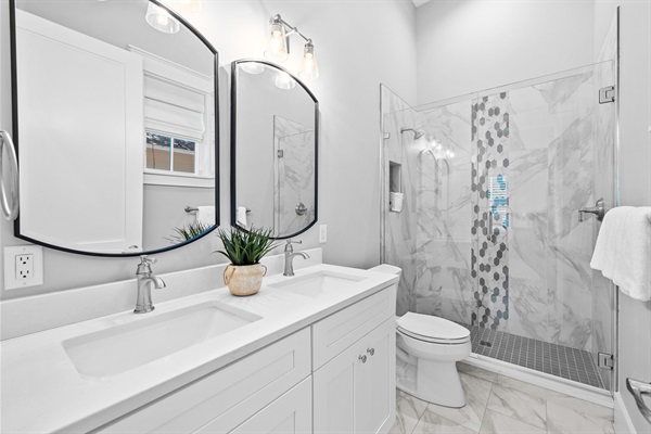 1st floor ensuite bathroom with double vanity, walk in shower