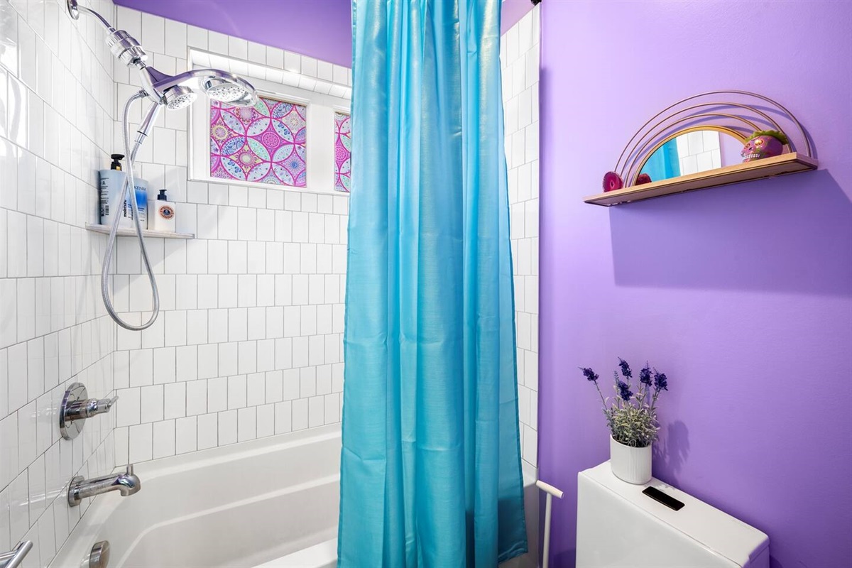 Full tub and shower with toilet. Rain shower head and hand held sprayer. 