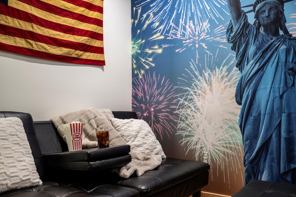 Celebrate America!  The Den has a couch and 70" Smart TV.