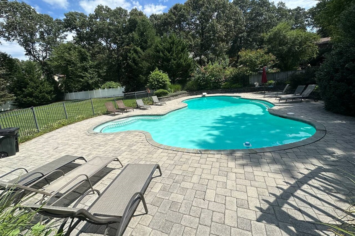 Pool has plenty of lounge chairs and is right next to back yard