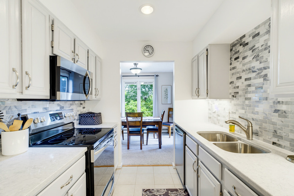 Our bright, fully equipped kitchen opens directly to the dining area, with golf course and tree tops views. We have what you need for prep, just bring the groceries!