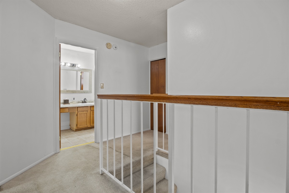 Upstairs door shows family full bathroom entrance.