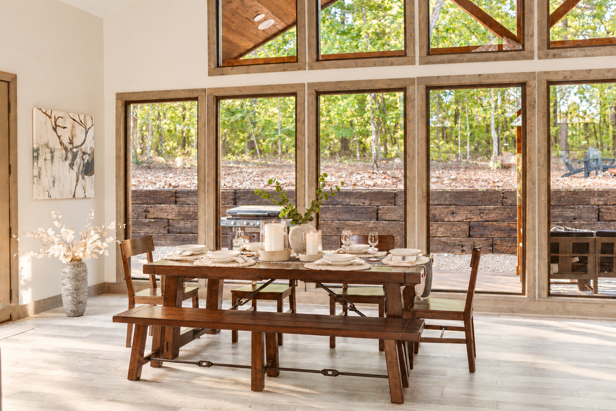 Dining area with large windows and views of the woods.