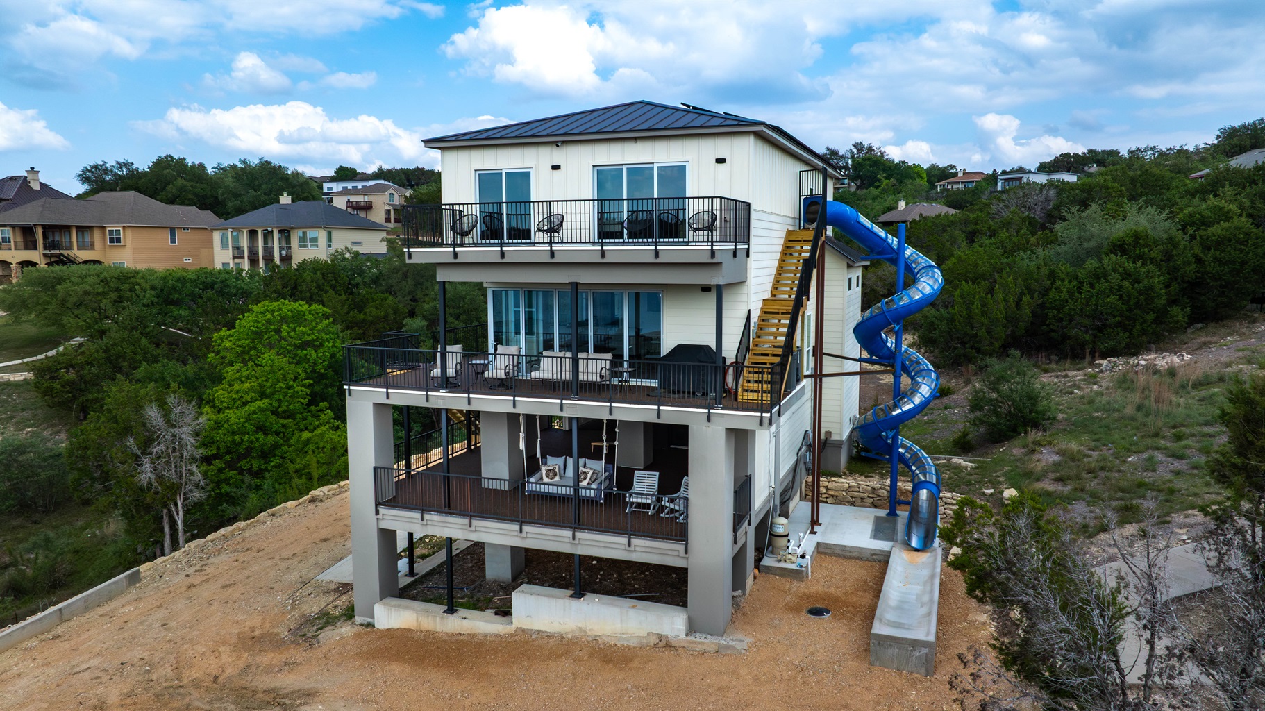 - 4 story slide attached to home adds nonstop fun for your stay - Exciting feature perfect for kids groups and lake travelers - Multiple balconies overlook scenic water views all around
