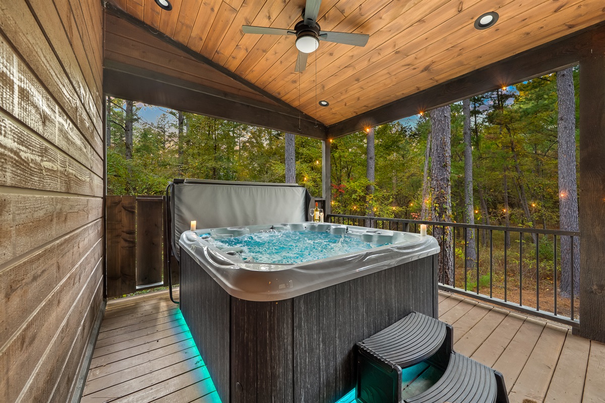 Steamy hot tub sanctuary under a wood lined ceiling with twinkle lights and pine filled views all around.