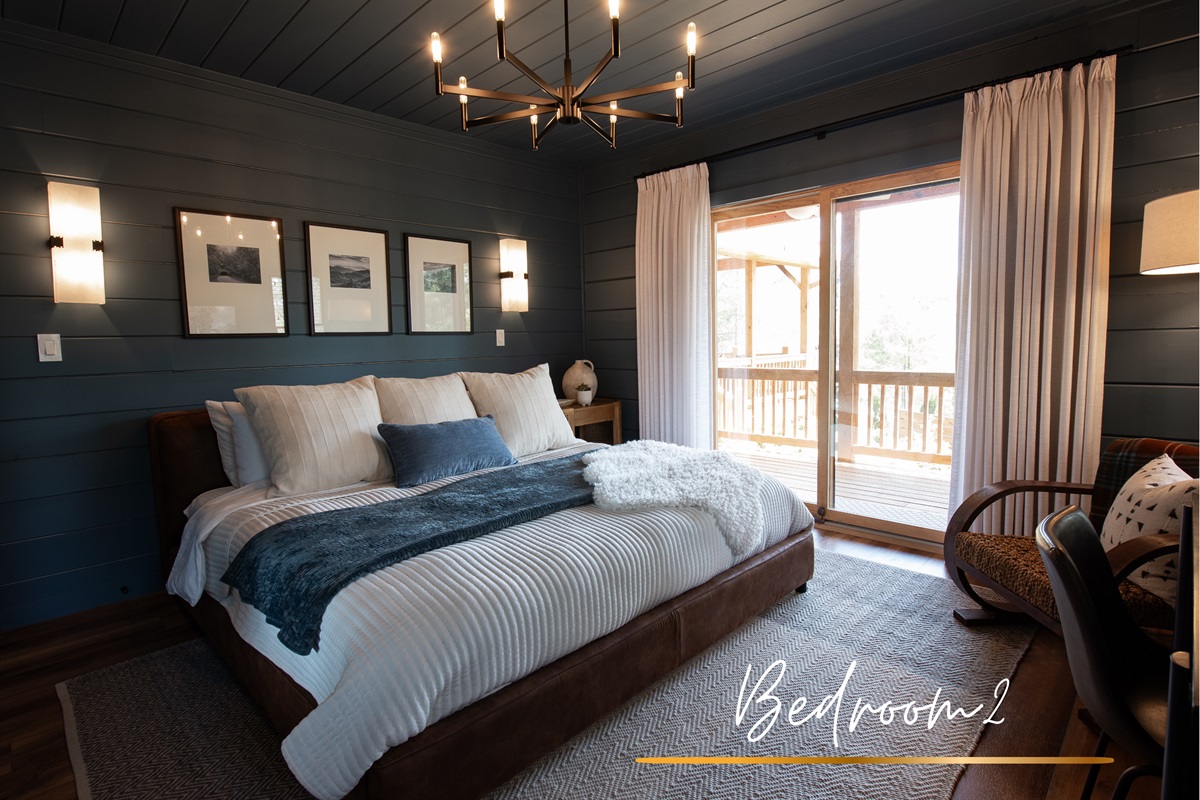 Bedroom 2 &ndash; A cozy retreat with a plush king bed, warm modern d&eacute;cor, and private deck access for taking in the views.