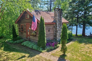 Historic Main log cabin view from above the parking lot towards Long Pond, Maine