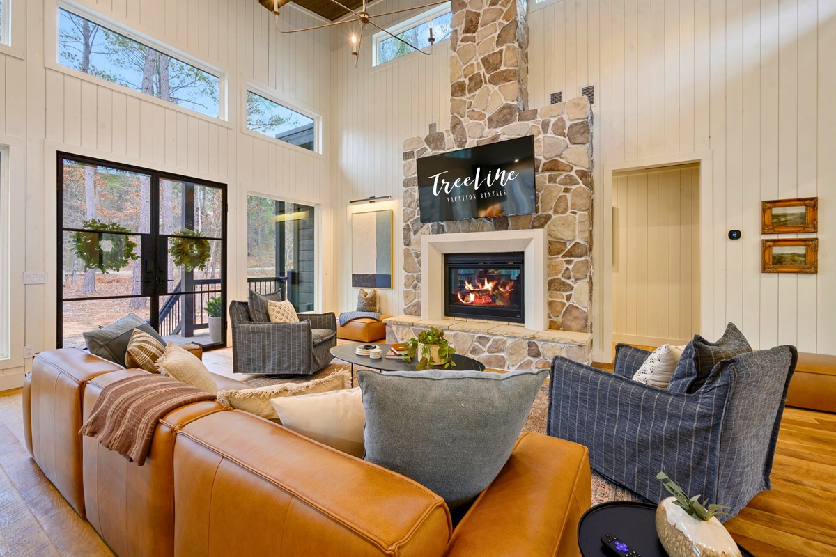 Warm tones and big windows create a bright, comfortable living area that feels both spacious and homey.