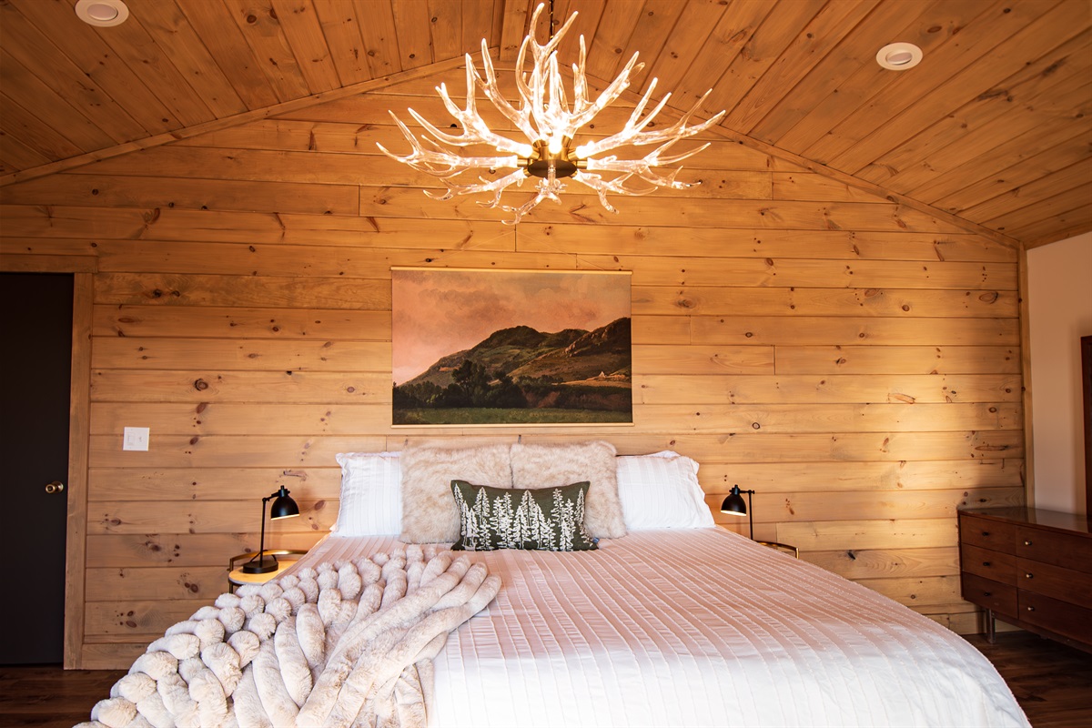 The spacious primary suite will have you staying in bed ALL DAY! Cozy memory foam mattress, fireplace, smart TV and more make this everyone's  favorite spot in the cabin.