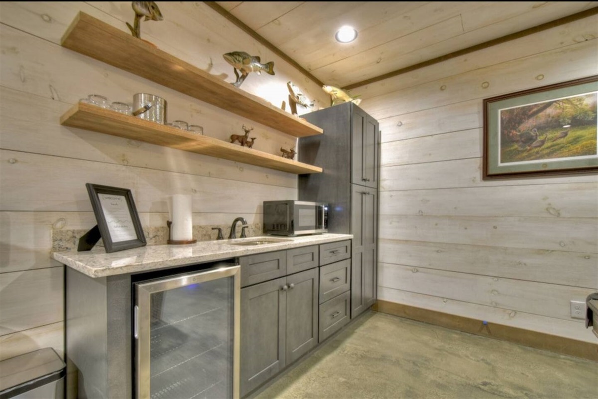 Lower level wet bar with mini fridge, Keurig, microwave, and game closet