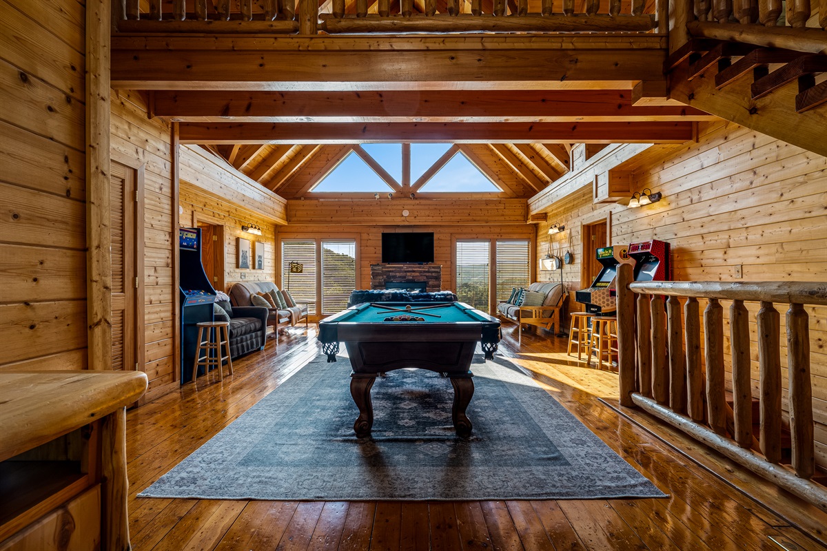 Spacious Game room with our full-size pool table, large TV, comfortable seating, arcade machines, and magnificent mountain views