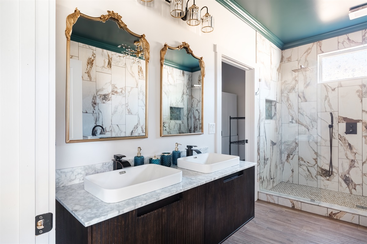 Elegant tilework, gold fixtures, and thoughtful accents create a serene, boutique hotel atmosphere that feels both elevated and intimate.