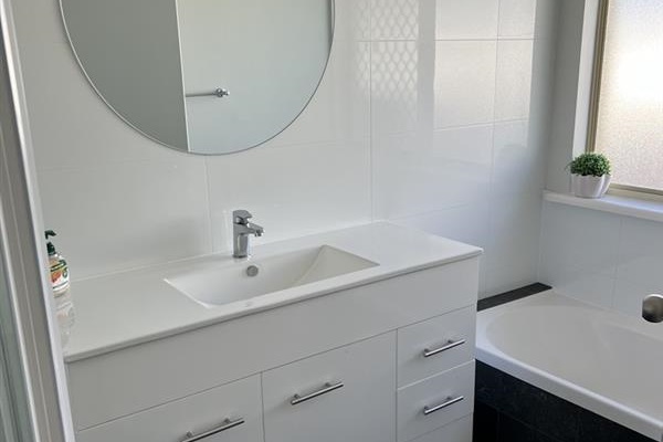 Main bathroom with separate bath tub & vanity