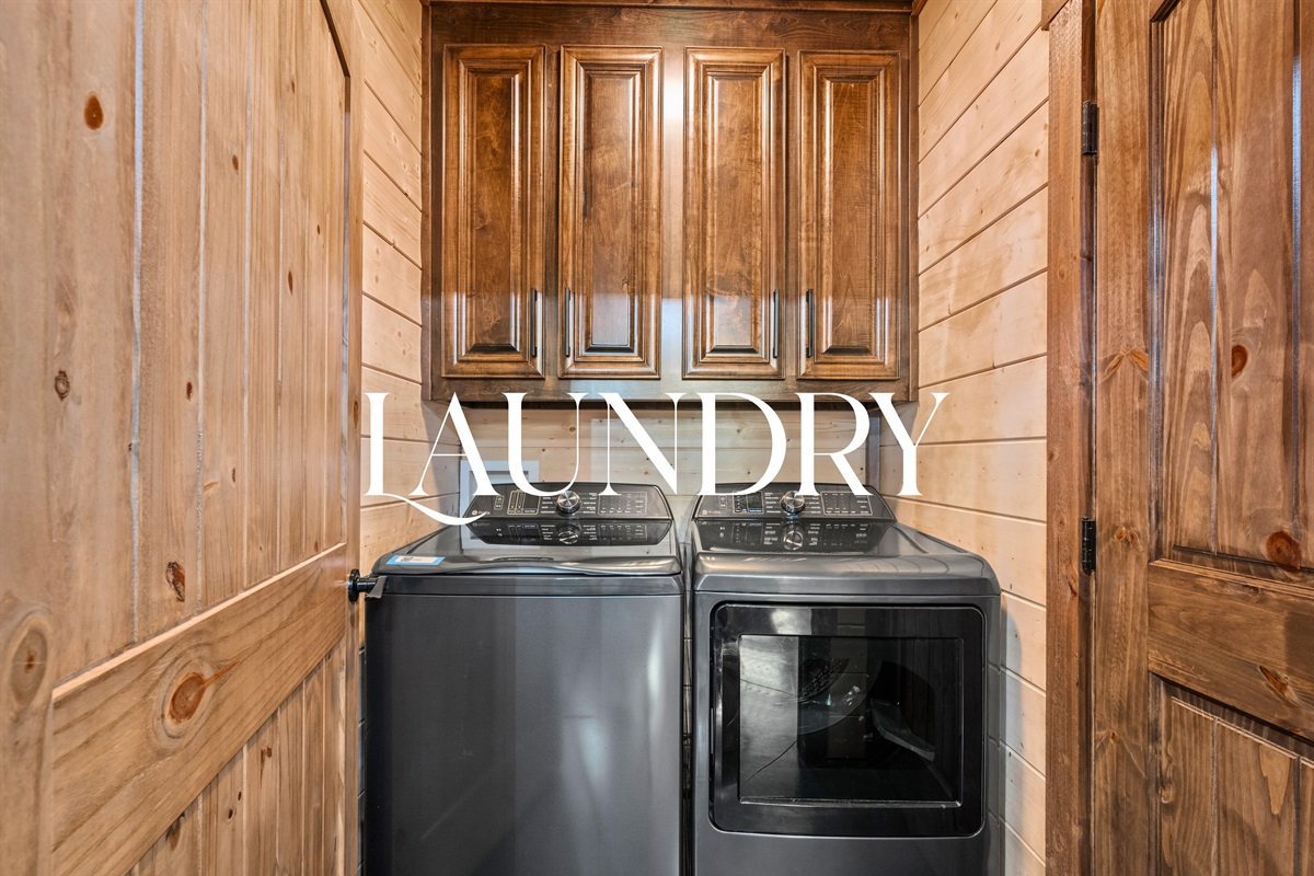 Laundry room with washer, dryer, and built-in shelving.
