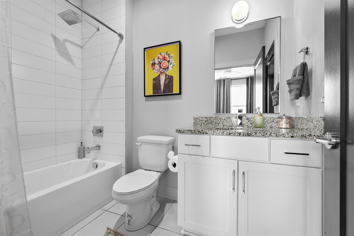 Bathroom Bliss: Modern elegance with a stylish flair, featuring granite countertops and chic decor!