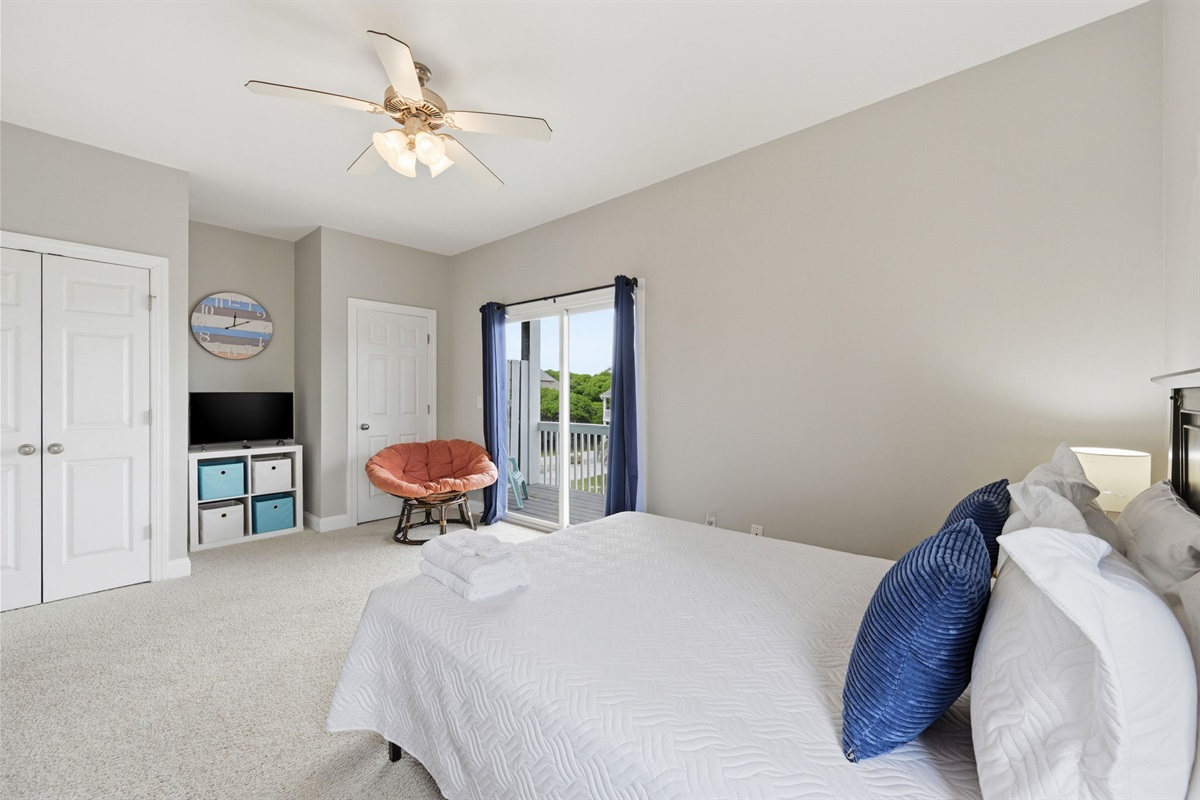 Bright and airy bedroom with balcony access and cozy seating