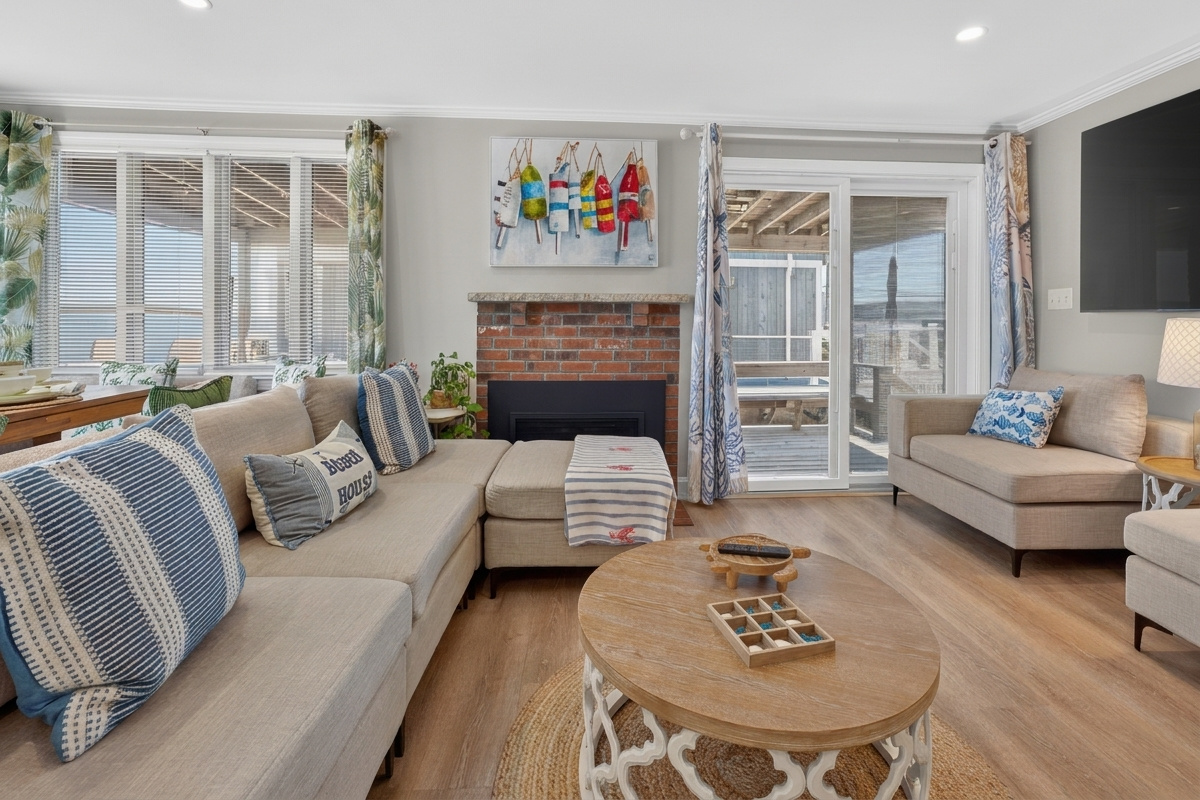 Relax beside the fireplace with comfortable seating and thoughtful coastal touches.