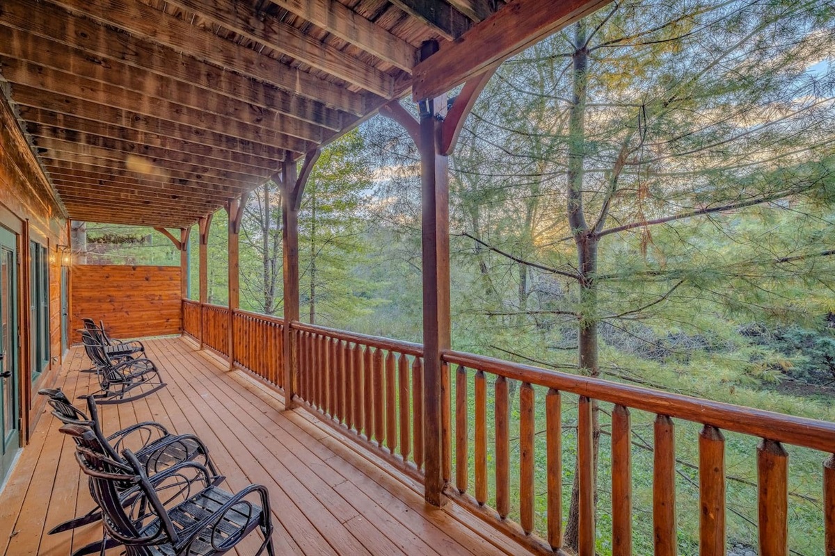 Covered deck with rocking chairs and Smoky Mountain views. Gatlinburg cabin rental at Gatlinburg Falls Parkview Resort &mdash; 3 miles from GSMNP.