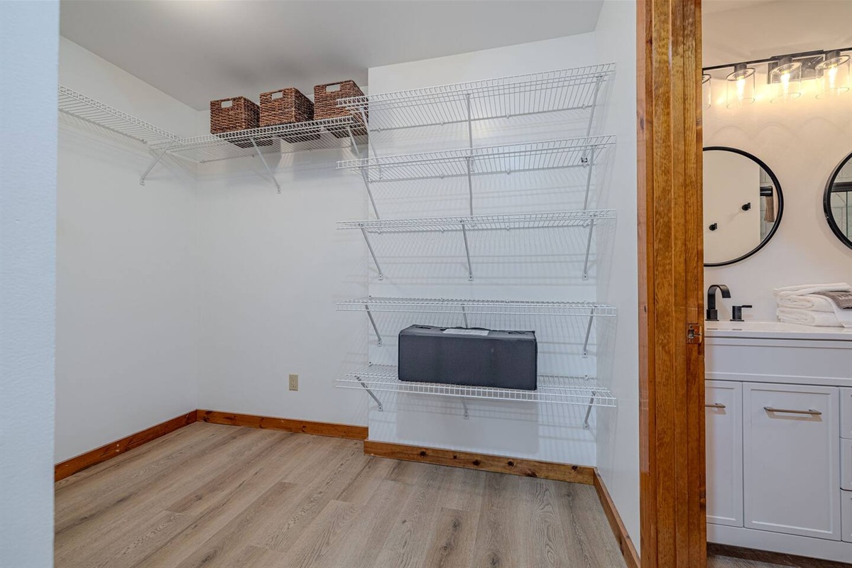 The expansive walk-in closet provides abundant storage and leads directly into the primary bathroom, creating a private, well-appointed suite experience.
