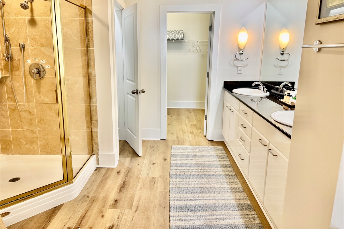 Spacious master bathroom with double vanity and large walk-in closet.