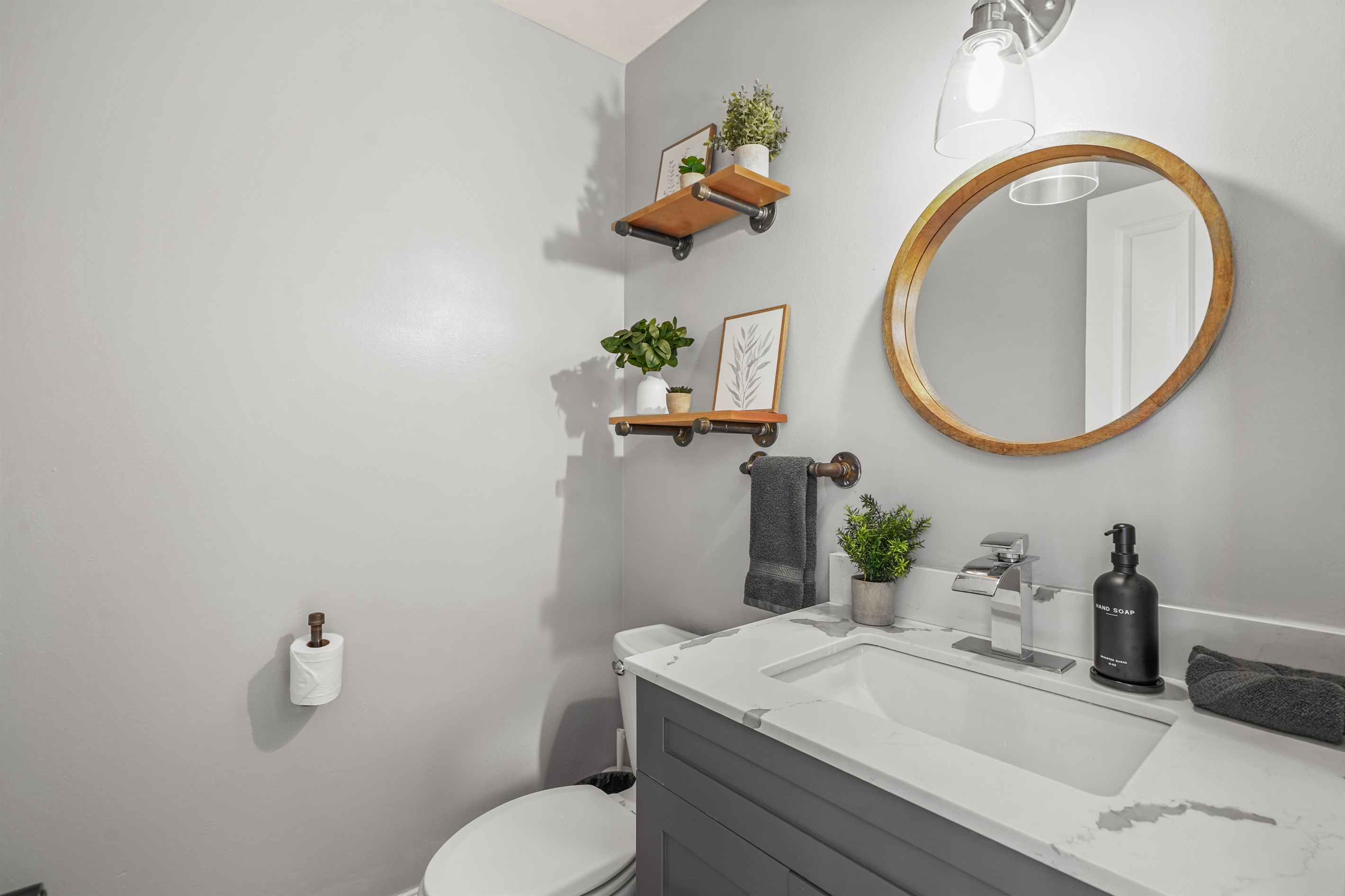 The downstairs half bathroom is conveniently located near the main living spaces, offering easy access for guests staying downstairs and for those gathering in the kitchen, dining, and living areas. Clean, functional, and thoughtfully maintained.
