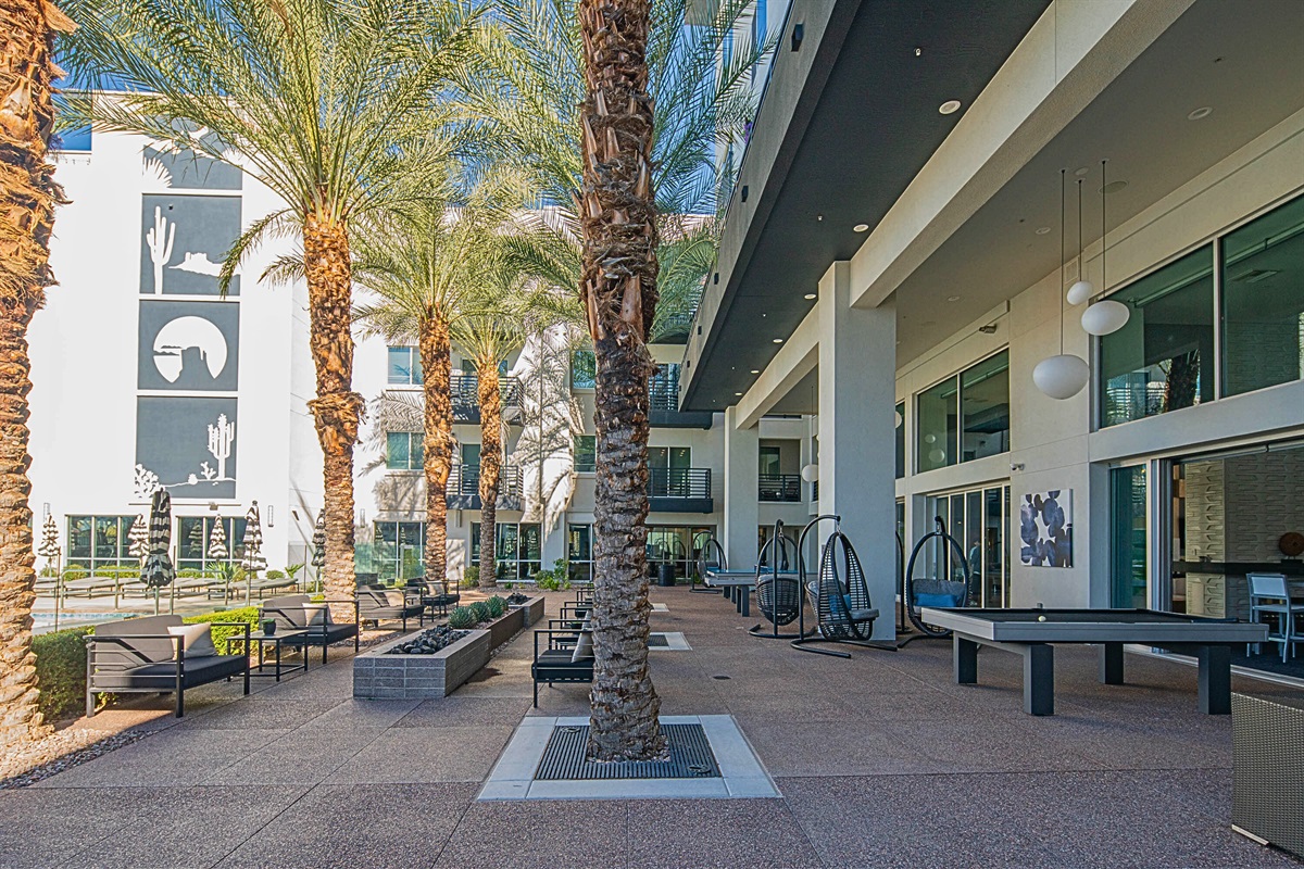 Oasis living with outdoor games and shady palms!