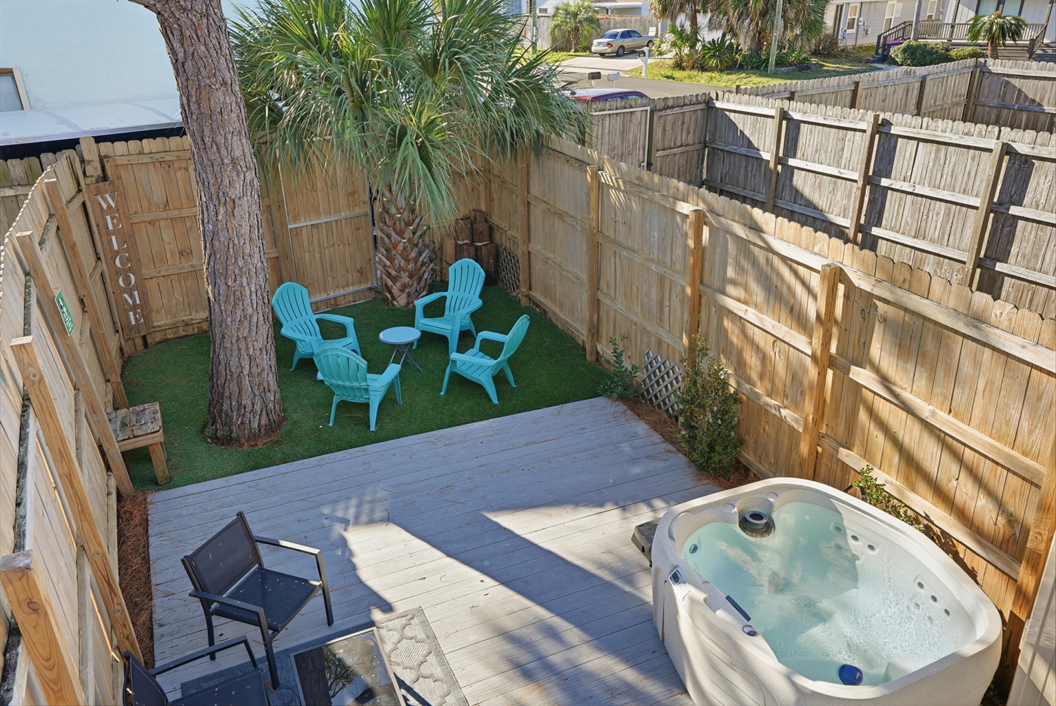 View From Balcony Overlooking Back Yard with Private Hot Tub  and Seating Area