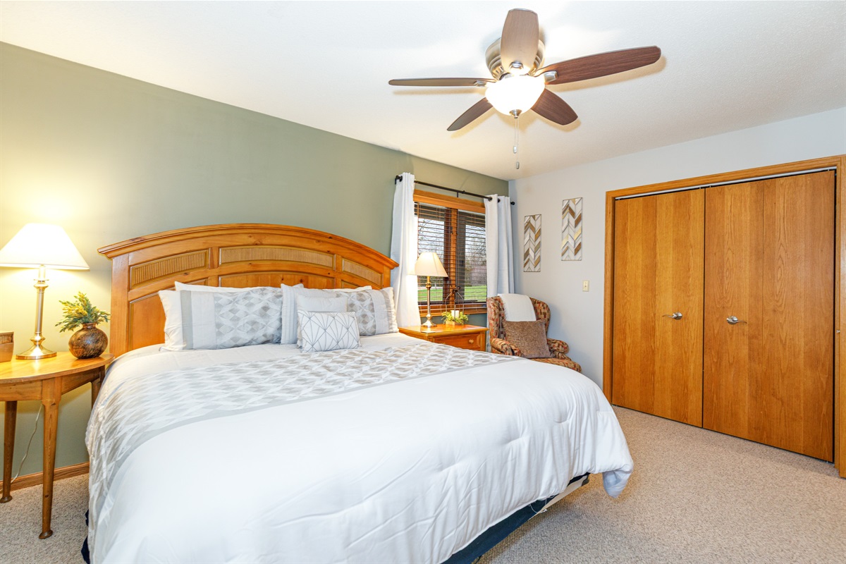 Main floor bedroom featuring a King bed and ensuite bathroom 
