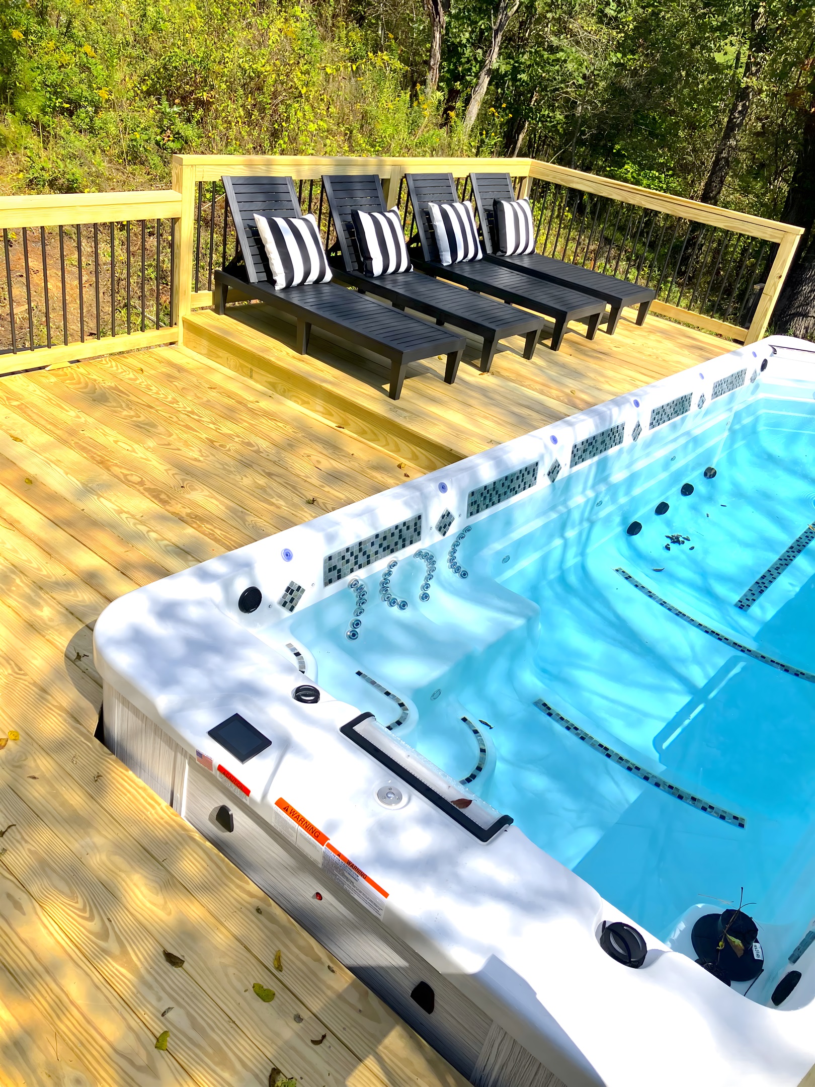 {Deck} Pool Loungers by the Heated 21 Ft Swim Spa.