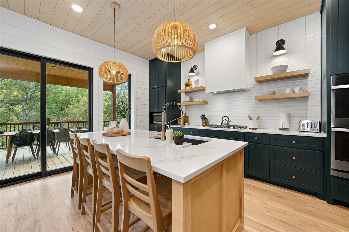 With double ovens and a gas cooktop, the beautifully appointed, well-equipped kitchen is perfect for cooking a meal for a family and friends.