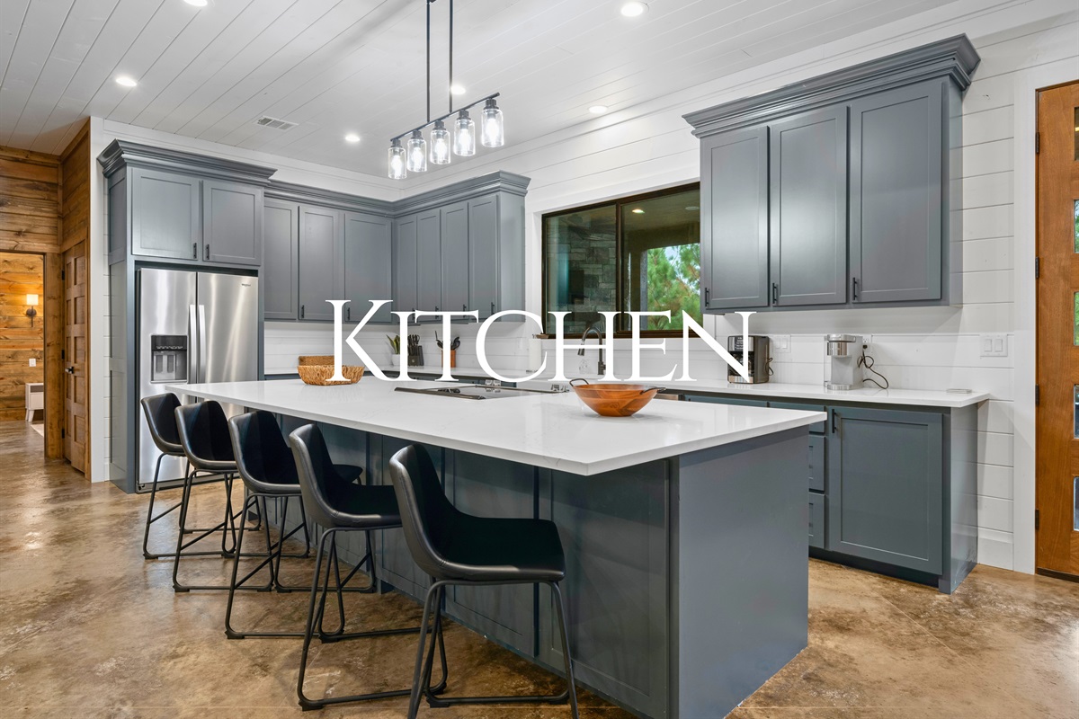 Bright, modern kitchen with bar seating and plenty of space to cook.