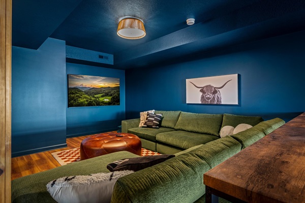 A cozy lower-level lounge made for movie nights—oversized sectional, 65” smart TV, and space for everyone to settle in and unwind.