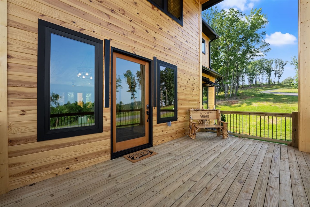 Welcome to the front porch, where warm wood accents and rustic charm set the tone for a serene mountain escape.