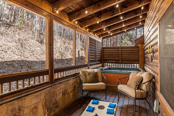 Back porch with hottub and cornhole 