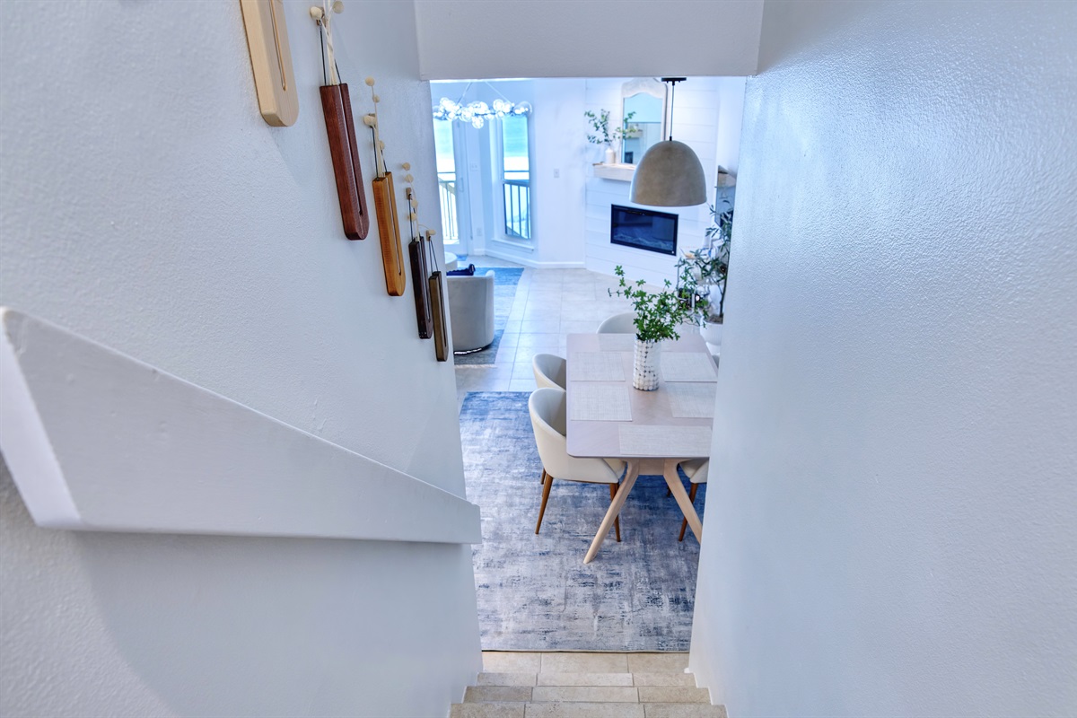 Steps leading down to the lower level: kitchen/dining room/living room/half bathroom area