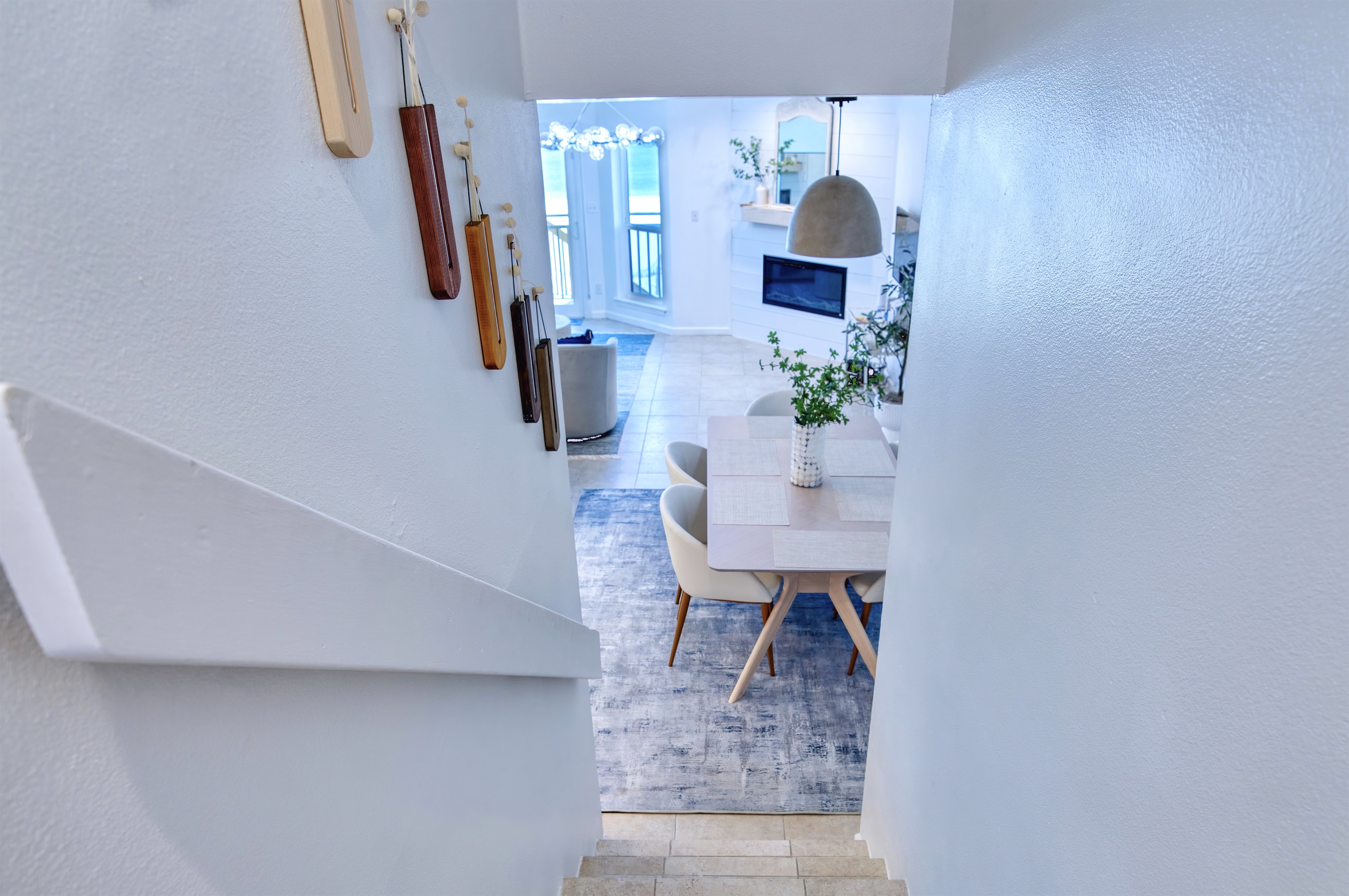 Steps leading down to the lower level: kitchen/dining room/living room/half bathroom area