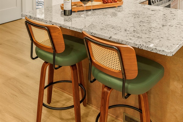 Two bar stools at the end of the kitchen counter are a perfect spot for a quick breakfast in the morning, or to keep the chef company while dinner is being made!