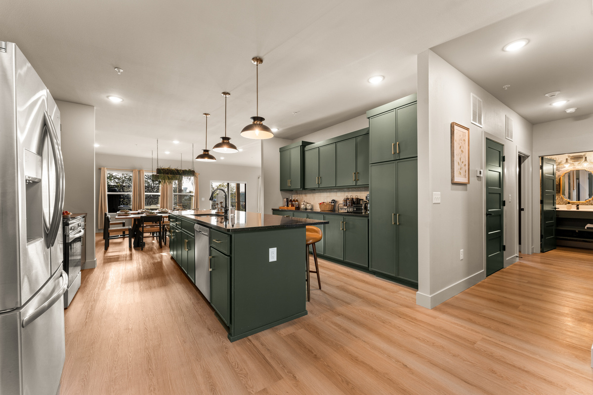 The open kitchen flows seamlessly into the surrounding living spaces for easy group entertaining.